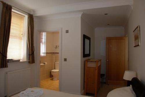 a bedroom with a bathroom with a toilet and a sink at Southover Beach in Woolacombe