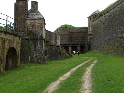 two people walking down a dirt road in a castle at Auberge de Marville in Marville