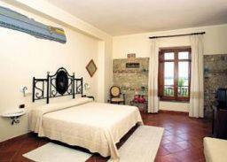 - une chambre avec un grand lit blanc et une fenêtre dans l'établissement Agriturismo La Casa Di Botro, à Botricello