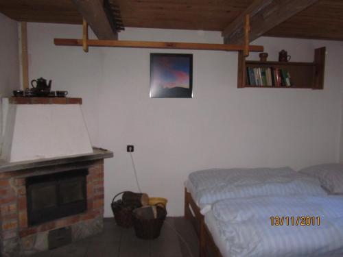 a bedroom with a bed and a fireplace at Horská Chata U Básníka in Horní Malá Úpa