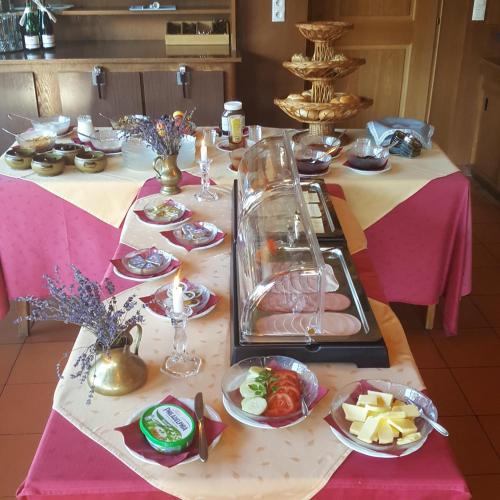 a table with plates of food on top of it at Pension Hüttwirt in Kössen