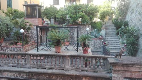 a balcony with a bunch of potted plants at Glam Resort Giulia in La Spezia
