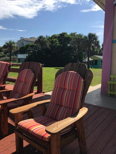 two rocking chairs sitting on a deck at South Beach Inn - Cocoa Beach in Cocoa Beach