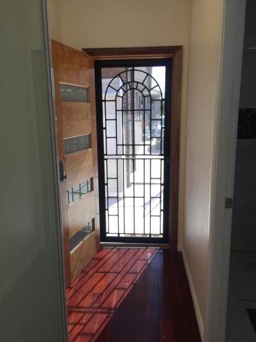 a door leading into a hallway with a window at Grannyflat in Bankstown