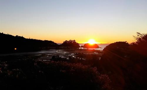 a sunset on a sunny day at Kimi Ora Eco Resort in Kaiteriteri