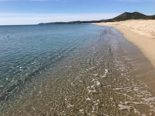 a beach with the shoreline at Camping Ermosa in Posada