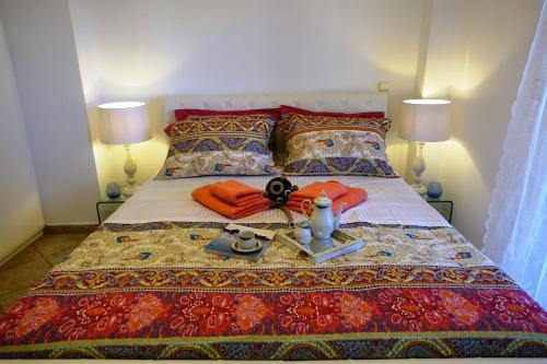 a bedroom with a bed with a table on it at Maisonette Ilios in Korfos