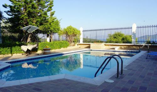 a swimming pool with a stairway leading to a pool at Maisonette Ilios in Korfos