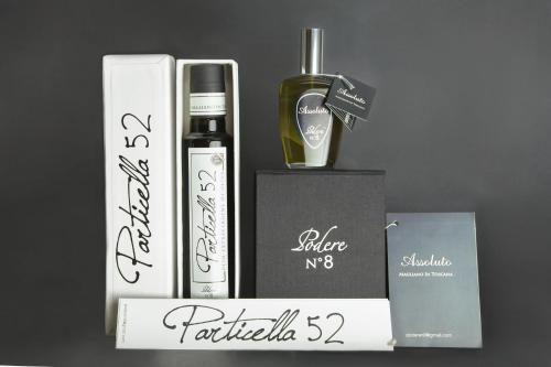 a gift box with a bottle of wine and a perfume at Podere n°8 Agriturismo in Maremma in Alberese
