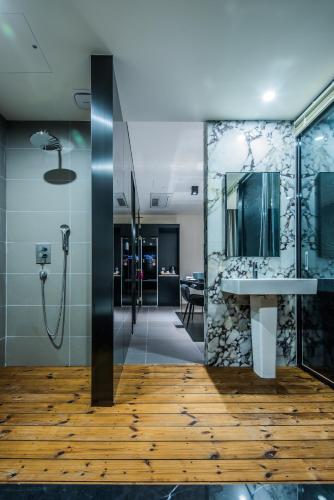 a bathroom with a shower and a sink at Rivertain Hotel in Daegu