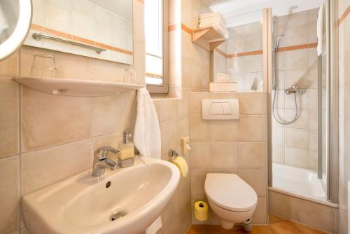 a small bathroom with a sink and a toilet at Arndt Hotel Garni in Rust