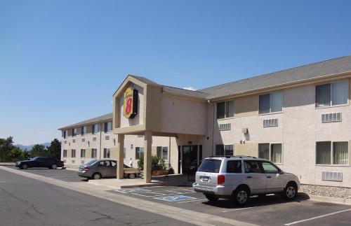 a car parked in a parking lot in front of a hotel at Super 8 by Wyndham Colorado Springs Airport in Colorado Springs