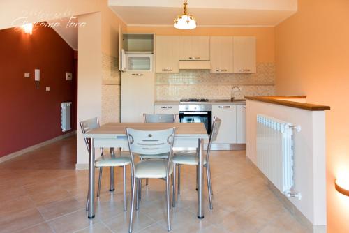a kitchen with a table and chairs in a room at Casa Sofia Vacanze A Montalbano Elicona in Montalbano Elicona