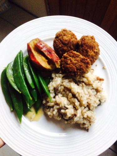 a plate of food with meatballs and rice and green beans at Kalahari Camelthorn Guesthouse and Camping in Askham