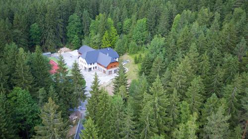 an aerial view of a house in the middle of a forest at Club Rezidence Pod Lučí in Loučovice