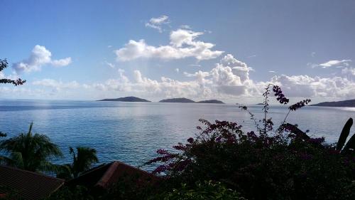 a view of a large body of water with mountains at Patatran Village Hotel in La Digue