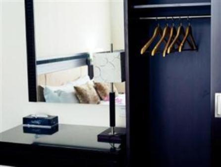 a mirror in a room with a table with a mirror at Hotel S Damansara in Kuala Lumpur