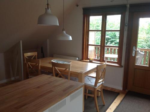 a dining room with a wooden table and chairs at FeWo Fleckeby an der Schlei in Fleckeby