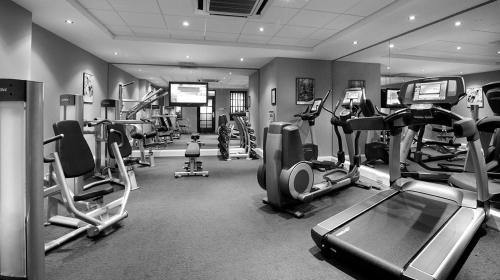 a gym with several treadmills and machines in a room at Pearltree Hotels And Resorts in Purulia