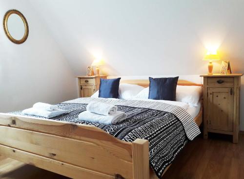 a bedroom with a bed with towels on it at U Kalíšku in Český Krumlov