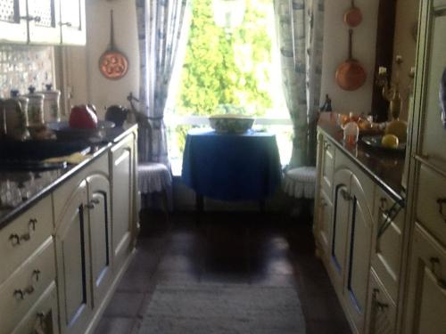 a kitchen with a table and a window with a table at Fornuddens Bed and Breakfast in Tyresö