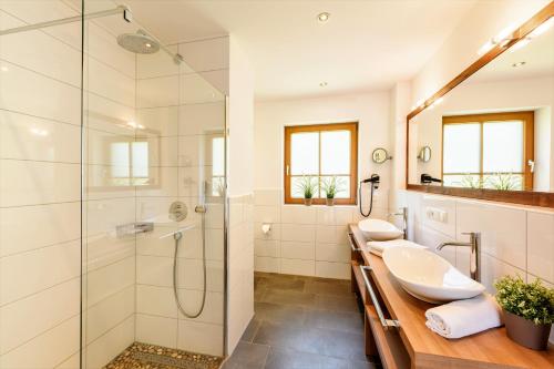 a bathroom with two sinks and a shower at Landhaus Stillachaue in Oberstdorf