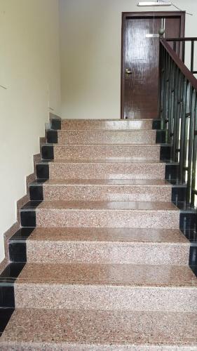 a set of stairs with a door in a building at Anand Agro Tourism Kashid in Alibaug