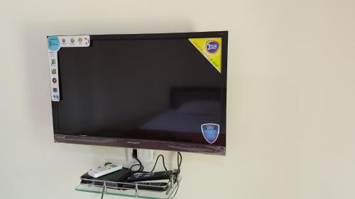 a flat screen tv hanging on a wall at Anand Agro Tourism Kashid in Alibaug