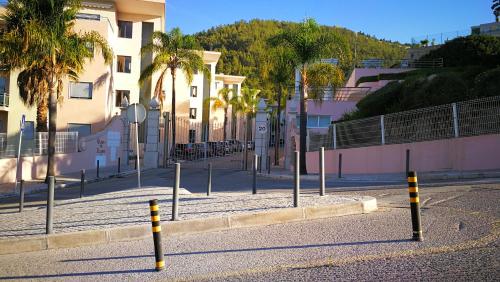 a street with poles on the side of a road at Quinta de Palames in Sesimbra