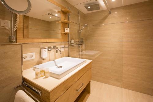 a bathroom with a sink and a shower at Superior Hotel Post Ischgl in Ischgl