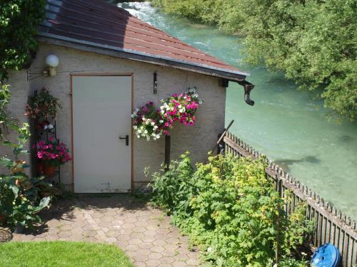 a small building with a door and flowers on it at Haus Höll Herta in Hallstatt