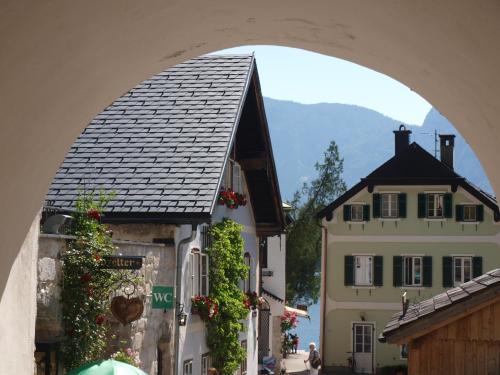 an archway over a street in a town with buildings at Haus Höll Herta in Hallstatt
