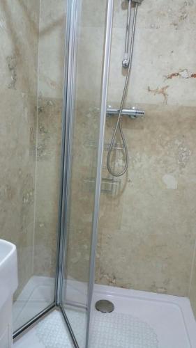 a shower with a glass door in a bathroom at St George Hotel Great Yarmouth in Great Yarmouth