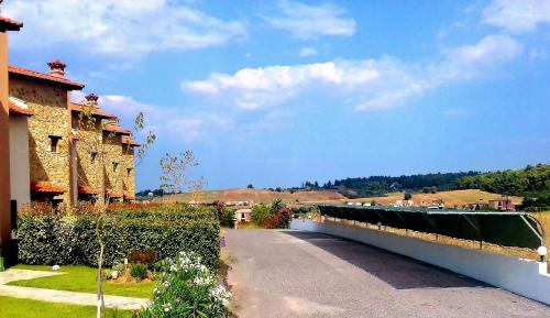 a road leading to a building with a fence at S4Sani in Sani Beach