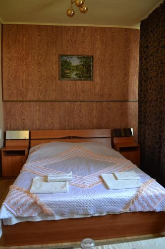 a bedroom with a bed with two towels on it at Hotel Rade 1 in Vratsa