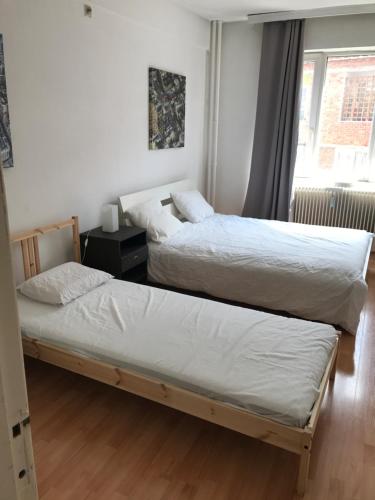 a bedroom with two beds and a window at Apartment Zaventem Brussels Airport J in Zaventem