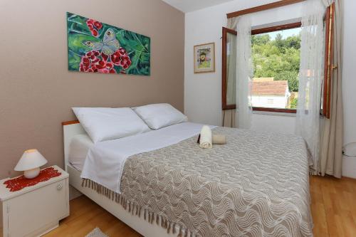 a bedroom with a large bed and a window at Waterfall House Getaway in Trilj