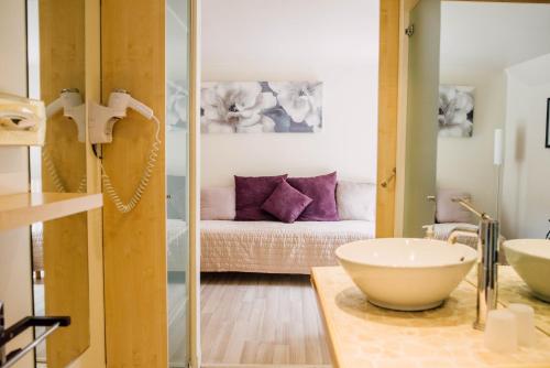 a bathroom with a sink and a bed at Chambre d'Hote Saint Malo in Saint Malo