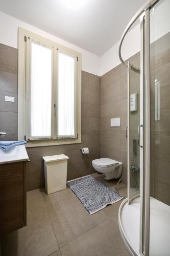 a bathroom with a toilet and a sink and a shower at Liberty Mansion in Venice-Lido