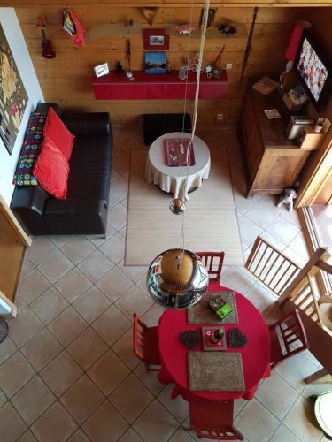 an overhead view of a living room with a red table at Arpege Des Neiges in Sainte-Foy-Tarentaise