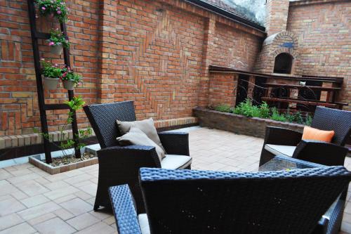 a patio with chairs and a table and a fireplace at Apartment Fine Living 122 in Vršac