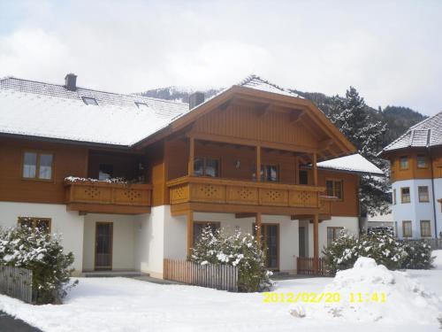 a house with a balcony in the snow at House Arianna in Bad Kleinkirchheim