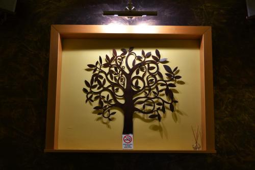 a framed picture of a tree on a wall at Apartment Fine Living 122 in Vršac