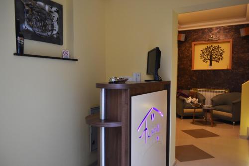 a room with a tv and a refrigerator with purple writing on it at Apartment Fine Living 122 in Vršac