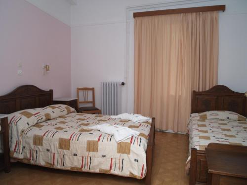 a bedroom with two beds and a window at Acropolis House in Athens