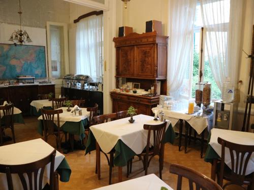 restauracja ze stołami i krzesłami w pokoju w obiekcie Acropolis House w Atenach