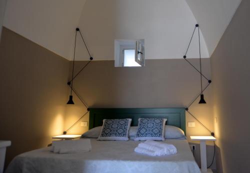 a bedroom with a bed with two pillows on it at Dammuso SOLMAR in Pantelleria