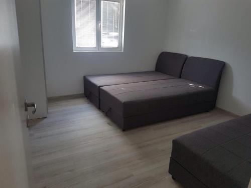 a room with a couch and a window in a room at Apartment Marijana in Tivat