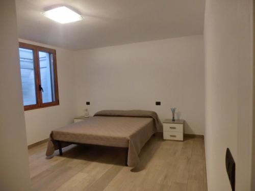 a bedroom with a bed and a window at La Costa Est Villa con Vista Mare in Ogliastra Sardegna in Tertenìa