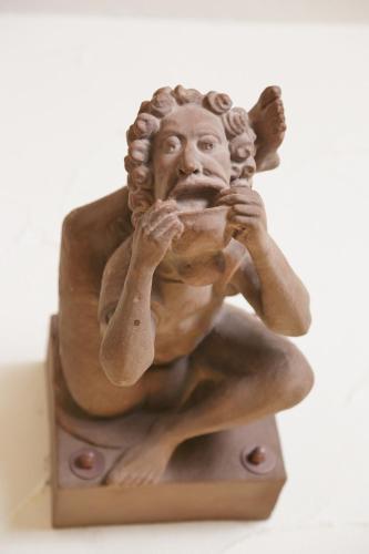 a statue of a man sitting on a stand at Park Hotel Post in Freiburg im Breisgau